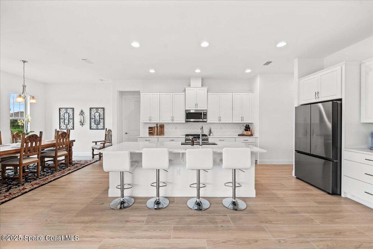 3234 Laming Way Melbourne, FL 32940 - Photo 10 of 59 a large white kitchen with lots of counter space and furniture