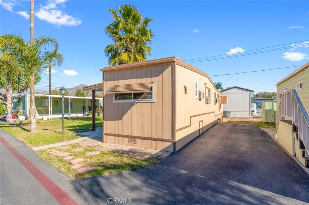 26235 9th Street, Unit 18 Highland, CA 92346 - Photo 2 of 31 a view of a house with a yard