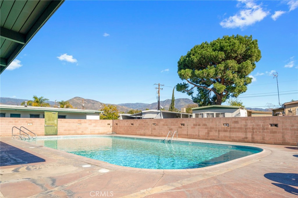26235 9th Street, Unit 18 Highland, CA 92346 - Photo 24 of 31 a view of a swimming pool with a yard
