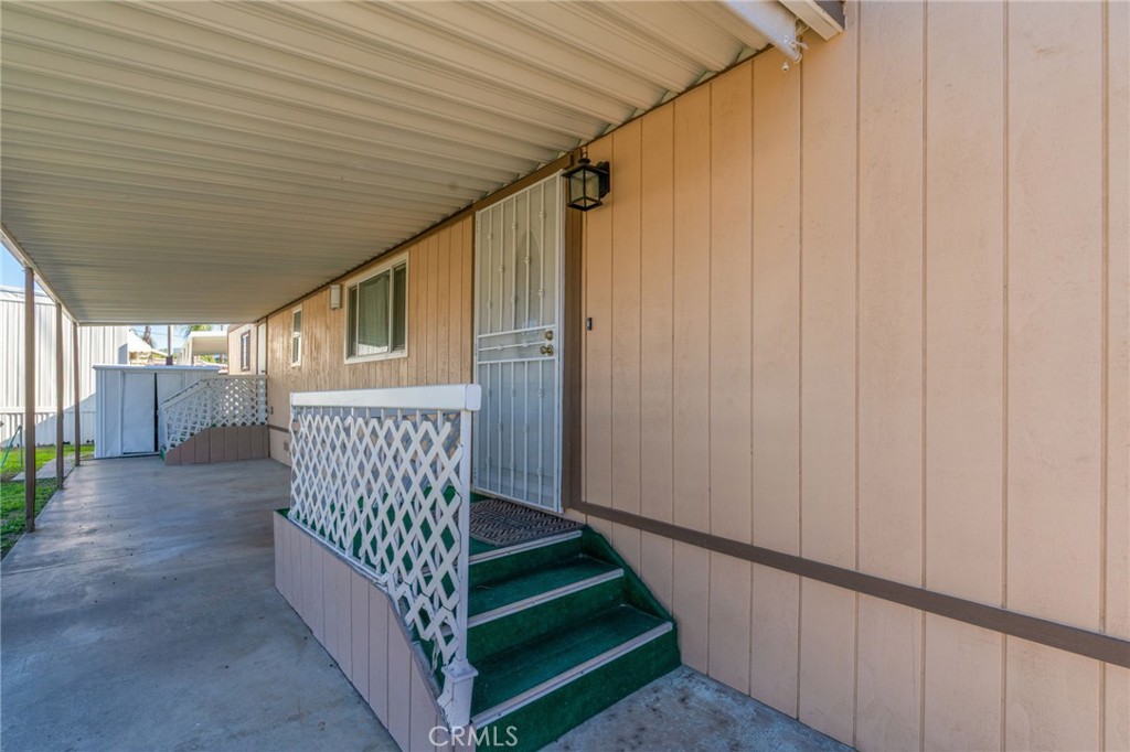 26235 9th Street, Unit 18 Highland, CA 92346 - Photo 30 of 31 a view of a porch with wooden floor and stairs