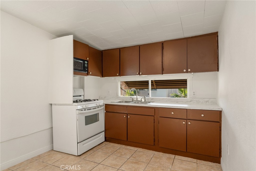 26235 9th Street, Unit 18 Highland, CA 92346 - Photo 6 of 31 a kitchen with a stove and a sink