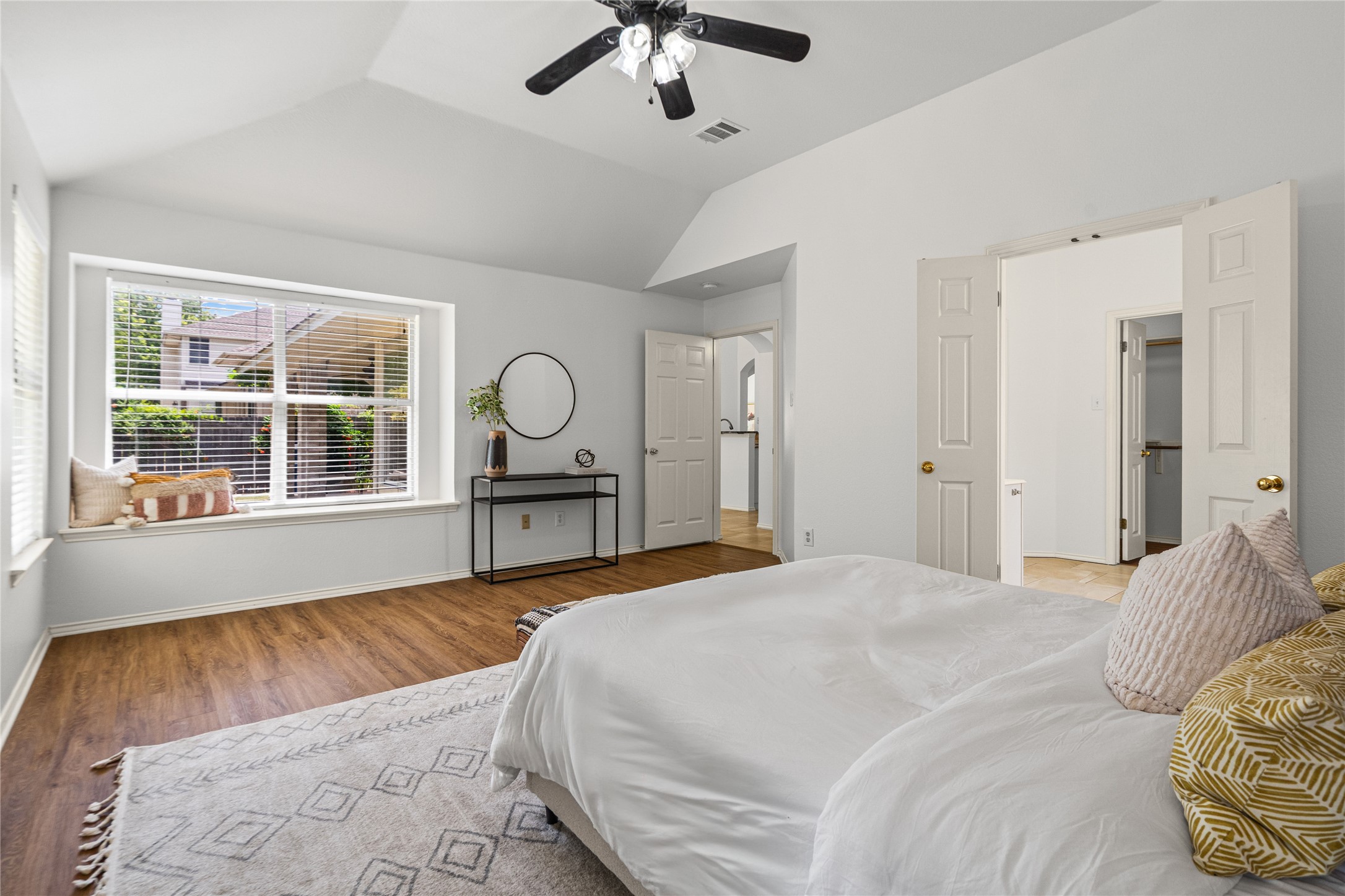 2920 Warwick Way Austin, TX 78748 - Photo 19 of 36 Abundant natural light flows into primary bedroom with charming window seat, tray ceiling, and wood-like flooring