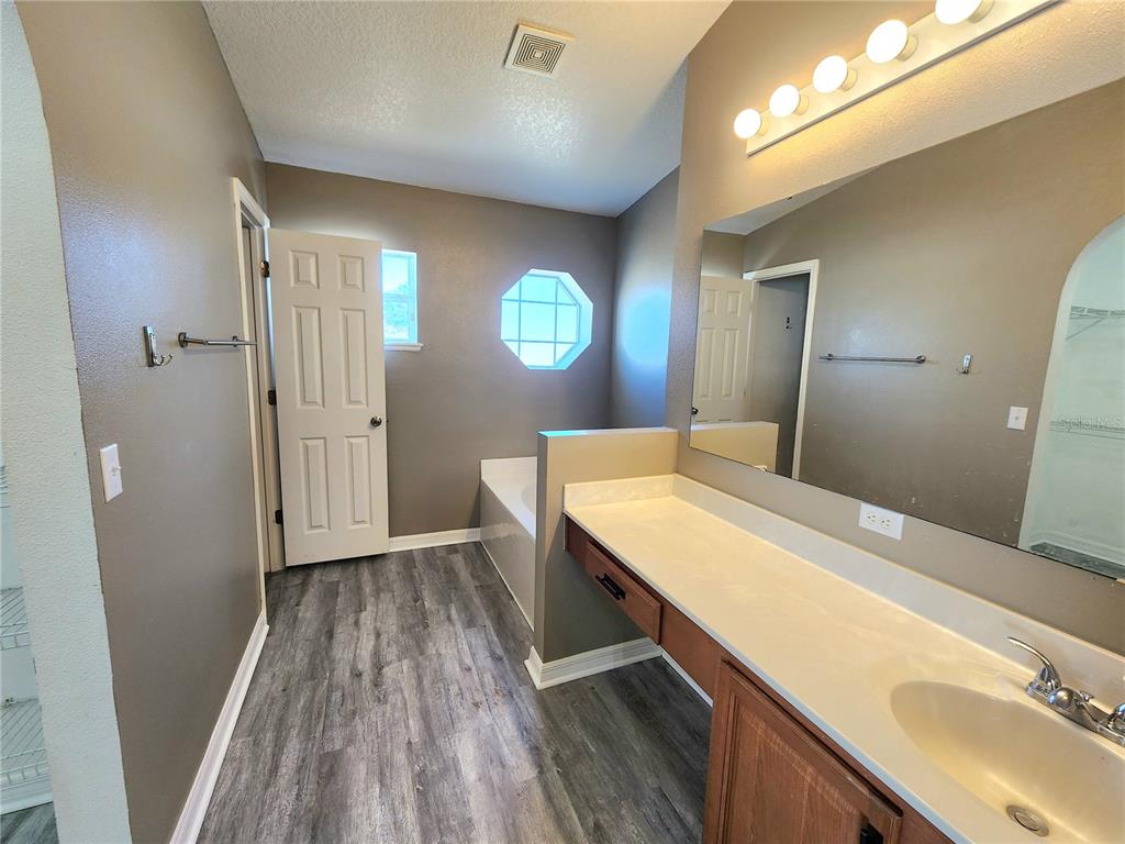 4017 Longworth Loop Kissimmee, FL 34744 - Photo 13 of 22 a view of a kitchen with wooden floor and a sink