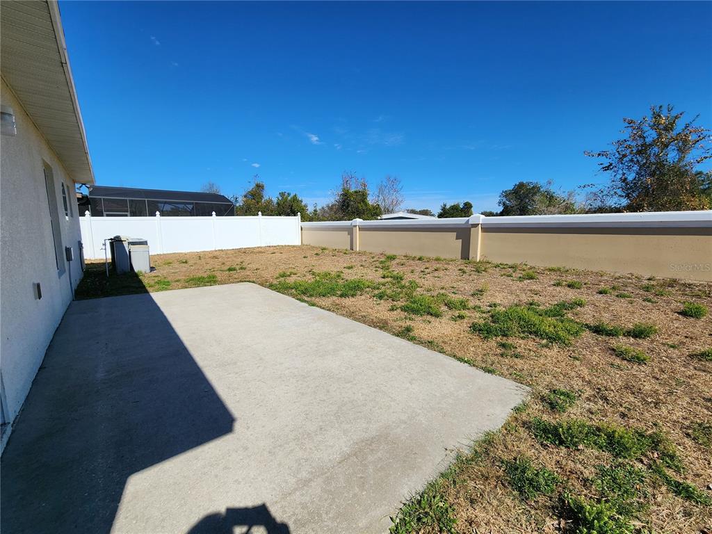 4017 Longworth Loop Kissimmee, FL 34744 - Photo 21 of 22 a view of a yard with wooden fence
