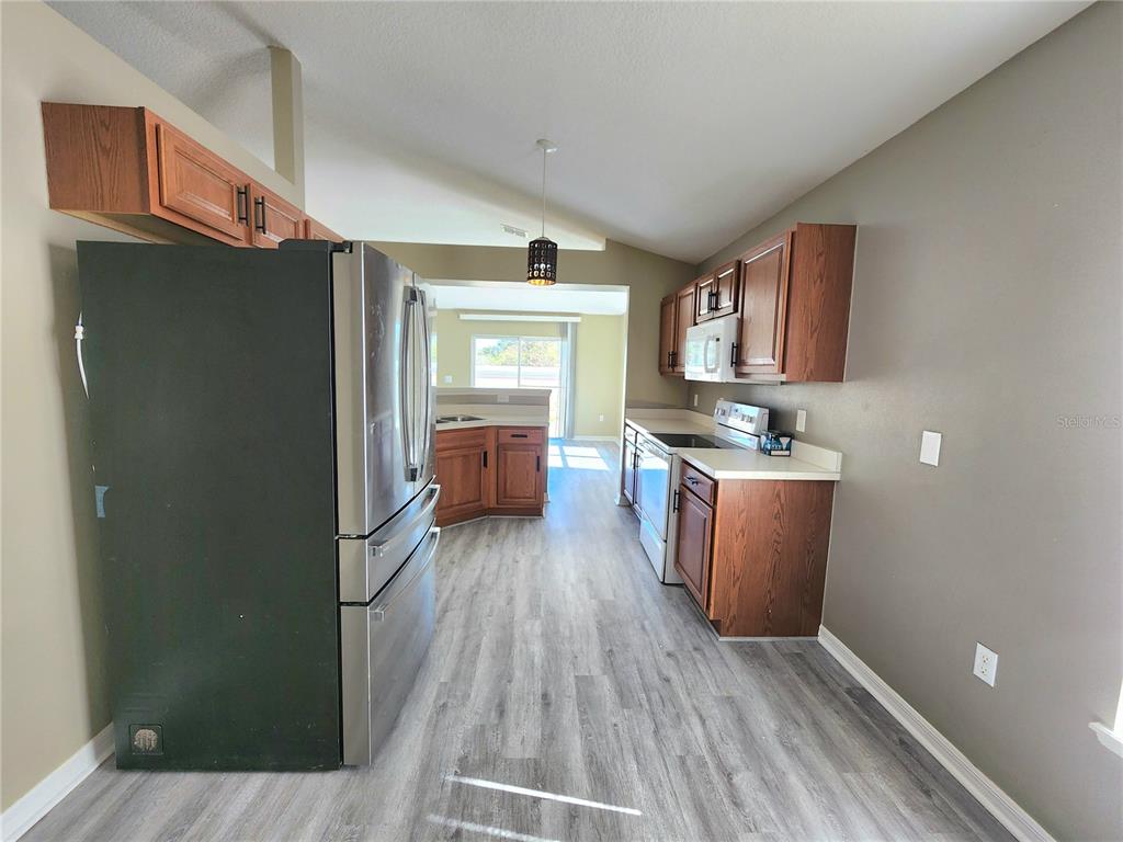 4017 Longworth Loop Kissimmee, FL 34744 - Photo 6 of 22 a view of kitchen with sink refrigerator and window