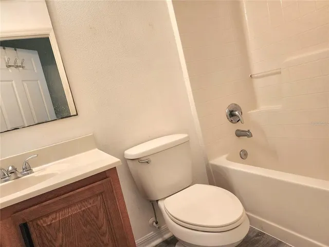 a white toilet sitting next to a bathroom sink