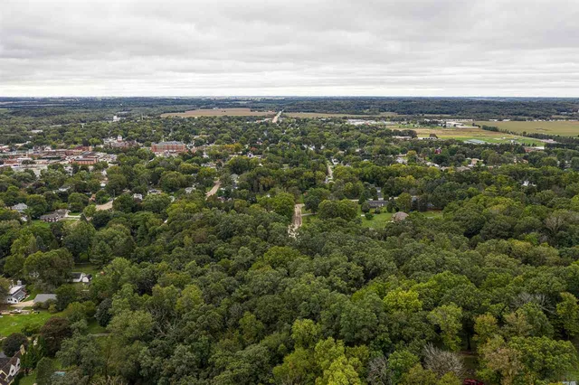 an aerial view of residential building with green space