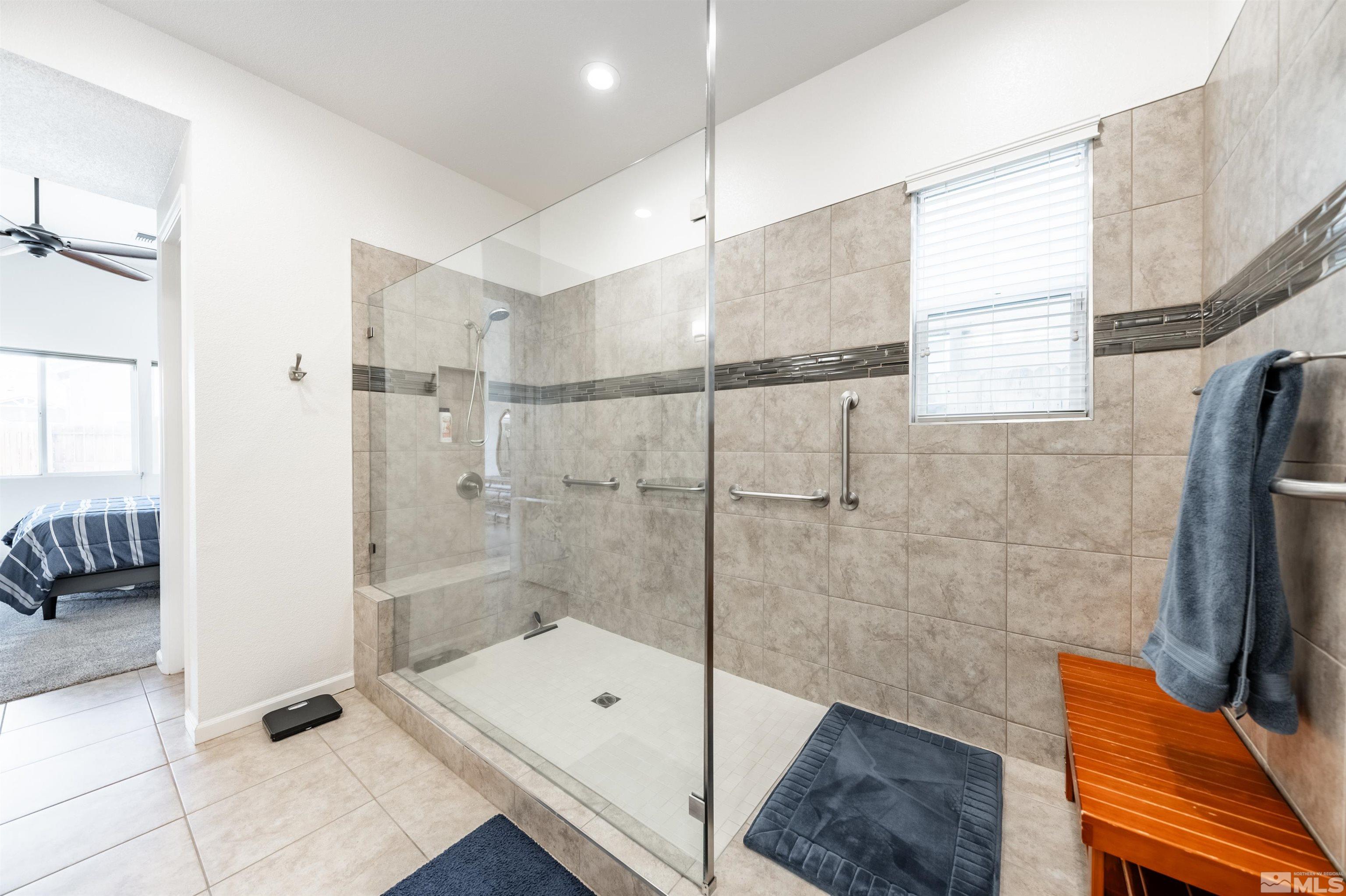 9494 Baldacci Road Reno, NV 89521 - Photo 11 of 34 a bathroom with a tub a window and a shower in it