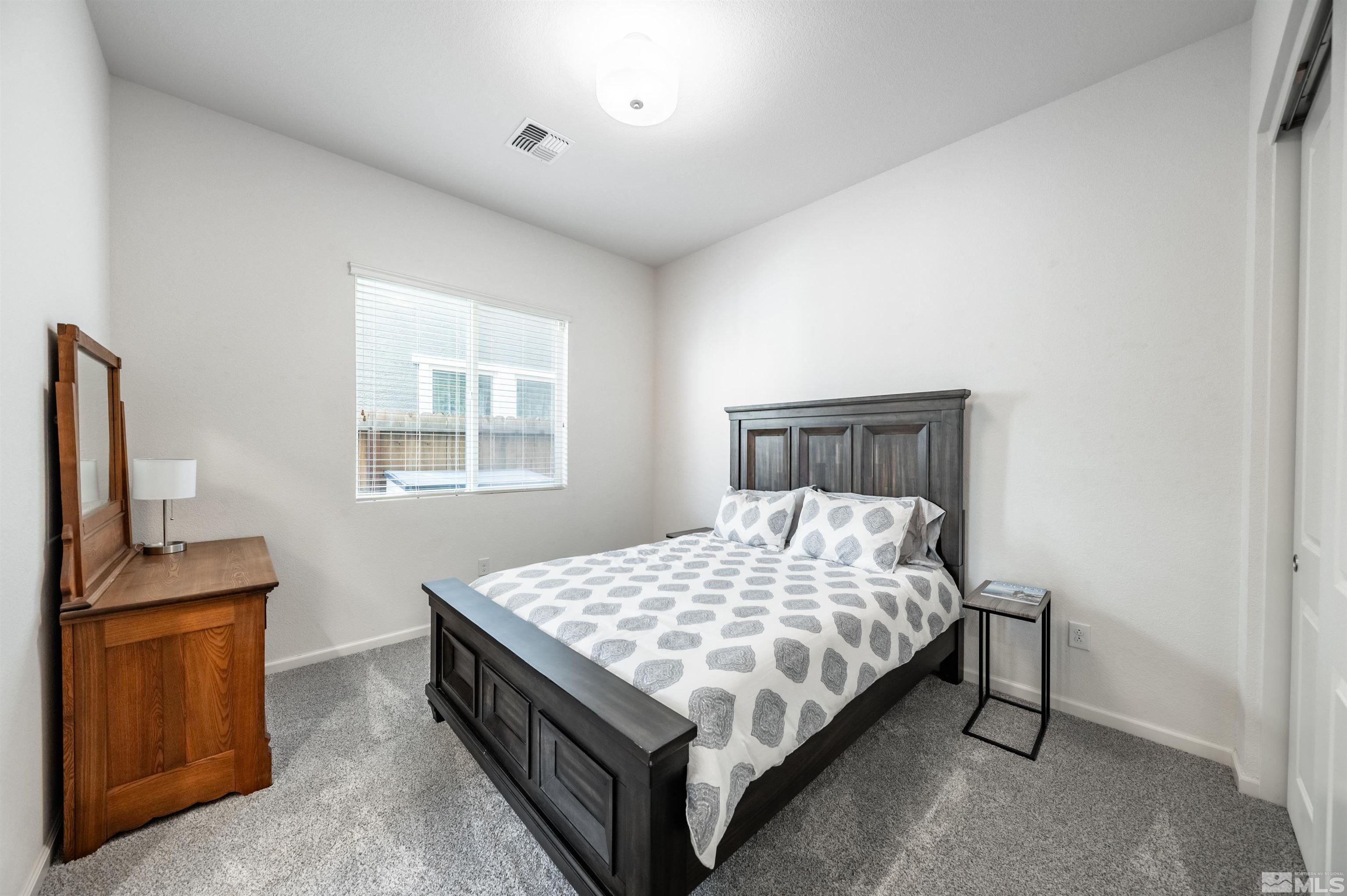 9494 Baldacci Road Reno, NV 89521 - Photo 12 of 34 a bedroom with a bed and wooden floor