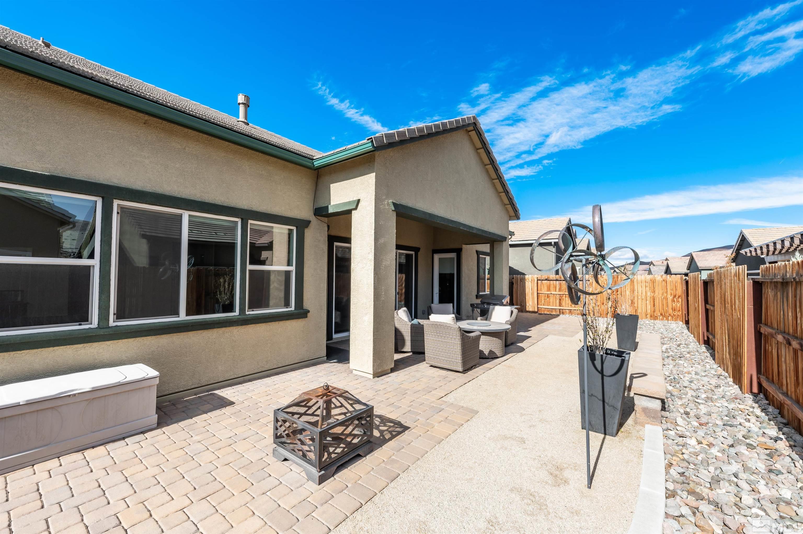 9494 Baldacci Road Reno, NV 89521 - Photo 18 of 34 a view of a patio with a dining table and chairs with wooden floor