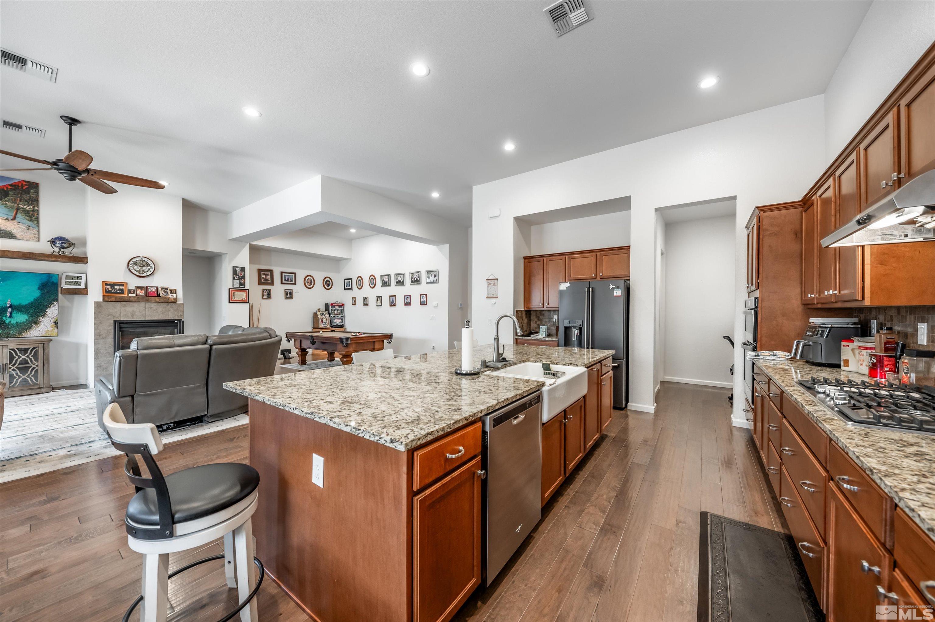 9494 Baldacci Road Reno, NV 89521 - Photo 4 of 34 a open kitchen with stainless steel appliances granite countertop a stove and a sink