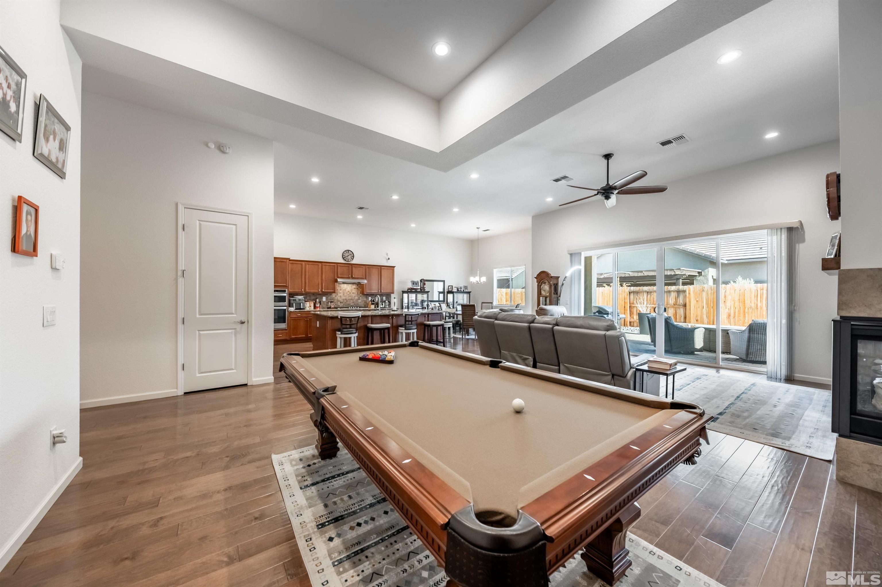 9494 Baldacci Road Reno, NV 89521 - Photo 6 of 34 a room with wooden floor table tennis pool table and chairs