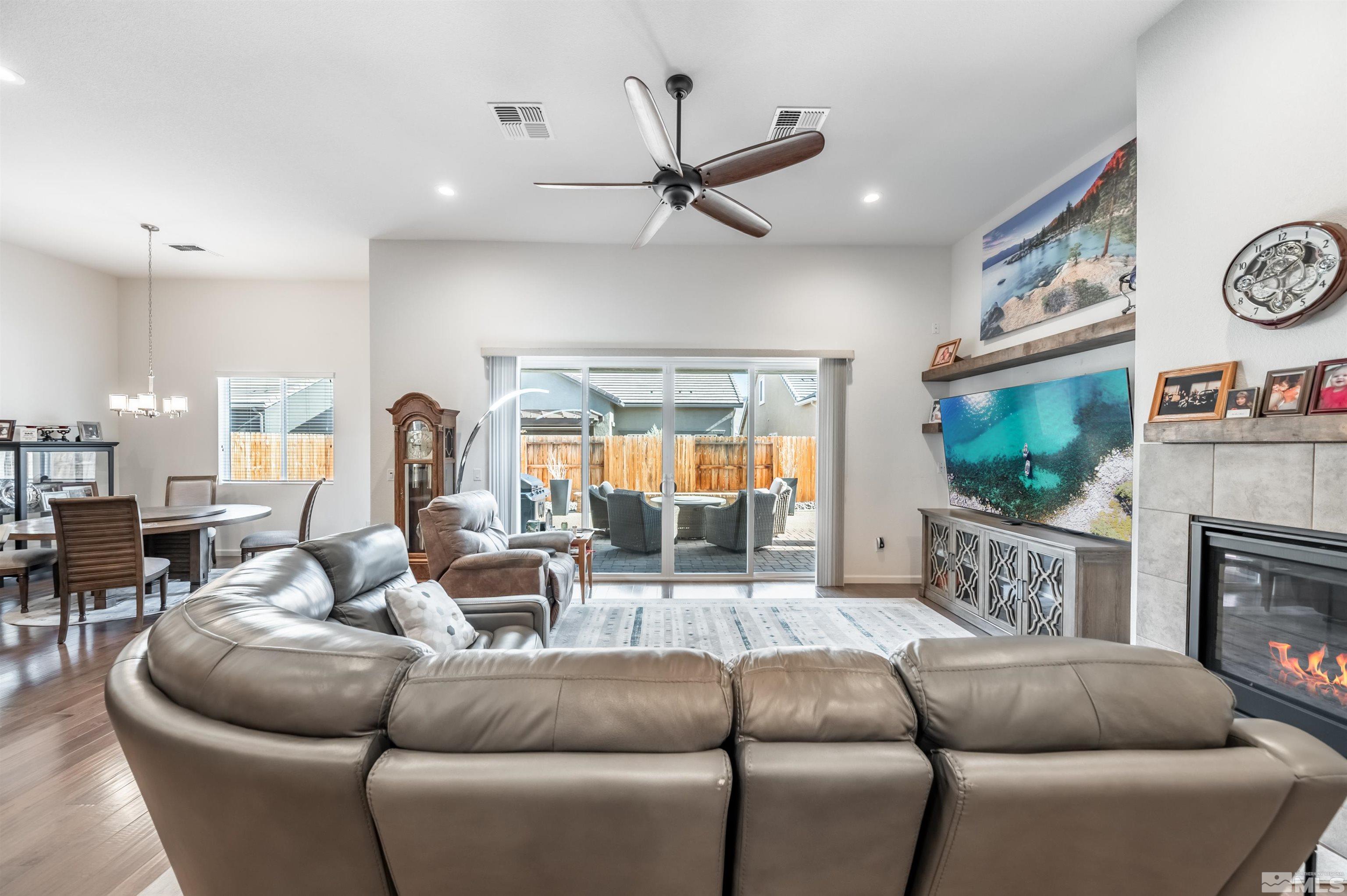 9494 Baldacci Road Reno, NV 89521 - Photo 7 of 34 a living room with furniture a flat screen tv and a fireplace
