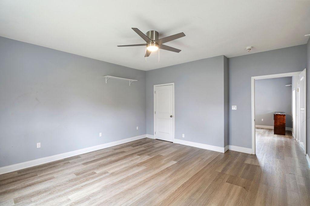 191 Elm Street Trion, GA 30753 - Photo 15 of 25 a view of a livingroom with wooden floor and a ceiling fan