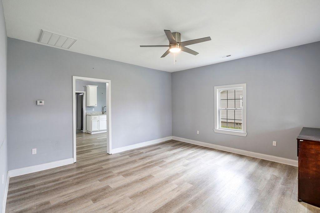 191 Elm Street Trion, GA 30753 - Photo 9 of 25 a view of an empty room with wooden floor and a window