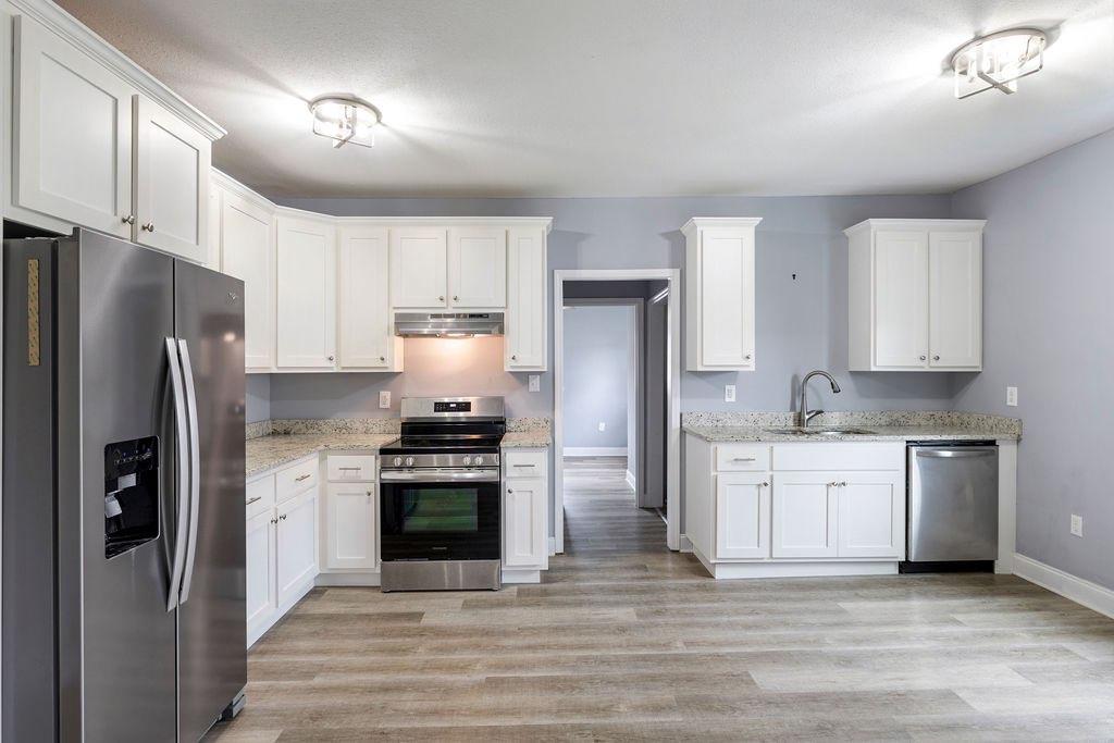 191 Elm Street Trion, GA 30753 - Photo 10 of 25 a kitchen with granite countertop a refrigerator stove and sink