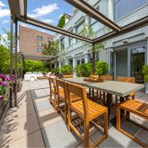 a view of a patio with a table and chairs and potted plants