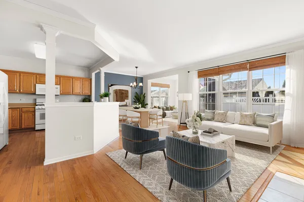 a living room with fireplace furniture and a large window
