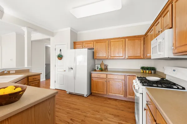 a kitchen with white cabinets and sink