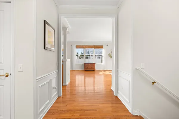 a view of a hallway with wooden floor
