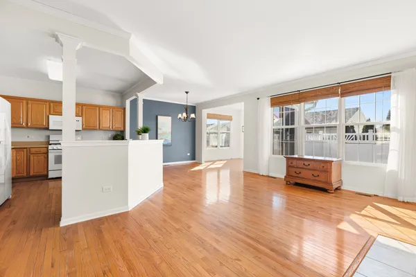 a view of living room kitchen with furniture and wooden floor