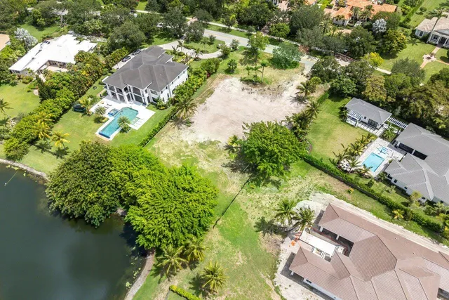 an aerial view of residential house with outdoor space and trees all around