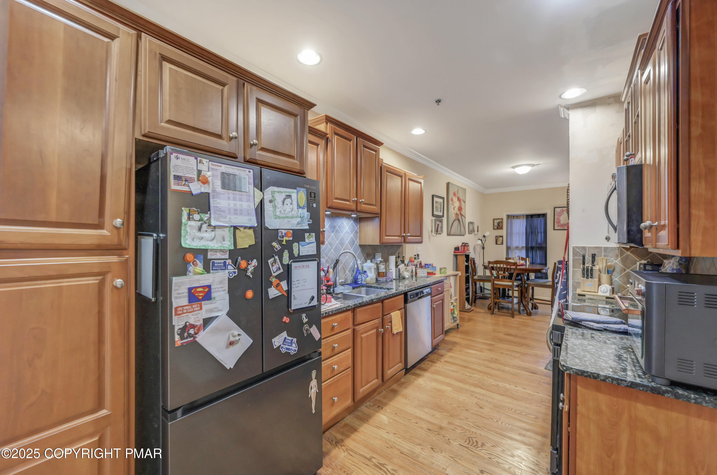 18 Elm Court, Unit UL3 East Stroudsburg, PA 18301 - Photo 16 of 48 a view of a kitchen with stainless steel appliances granite countertop a refrigerator and a view of living room