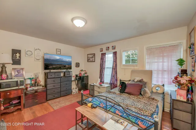 a bedroom with furniture and a flat screen tv