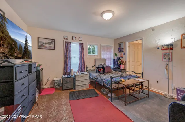 a bedroom with furniture and a flat screen tv