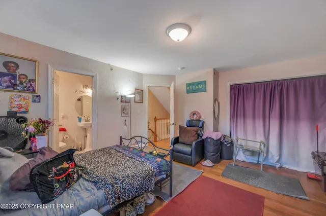 a bedroom with furniture and a wooden floor