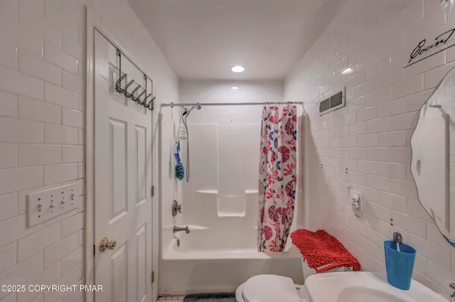 a bathroom with a bathtub and shower