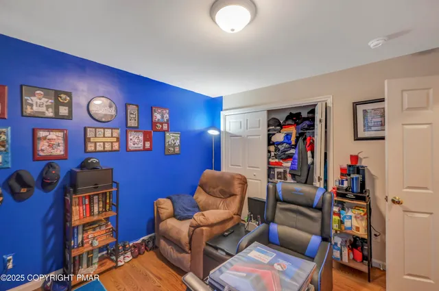 a living room with furniture and bookshelf