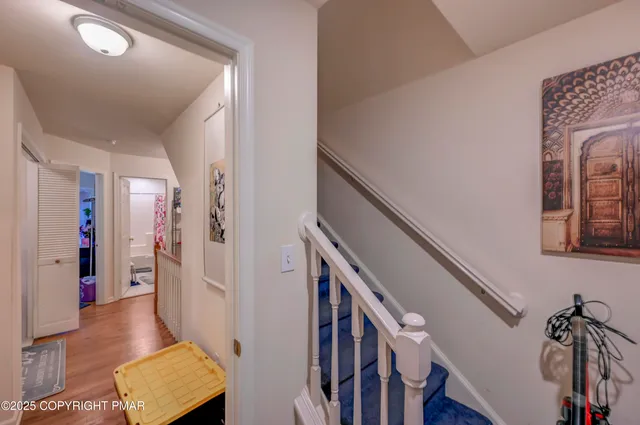 a view of an entryway with wooden floor and stairs