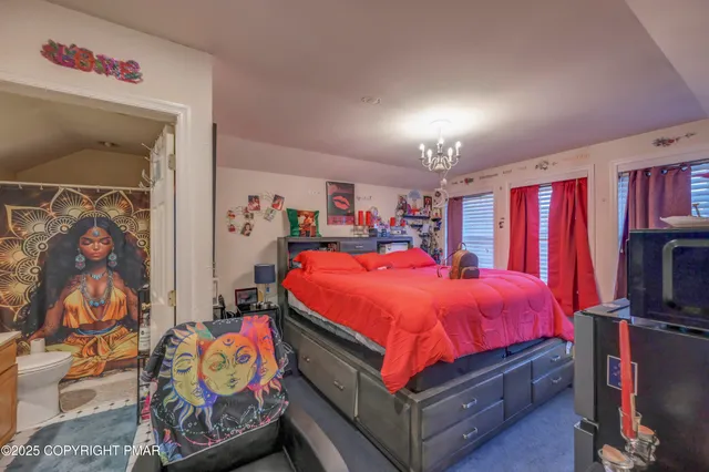 a bed room with a bed and a flat screen tv