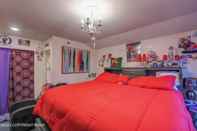 a bed room with a bed and a chandelier