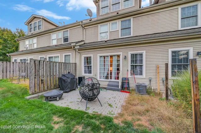a backyard of a house with yard fire pit and outdoor seating