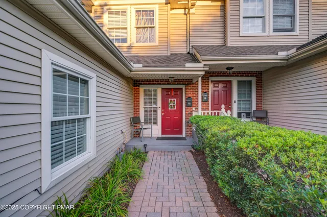 a view of brick house with large windows