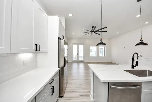 a kitchen with a sink a counter top space and cabinets