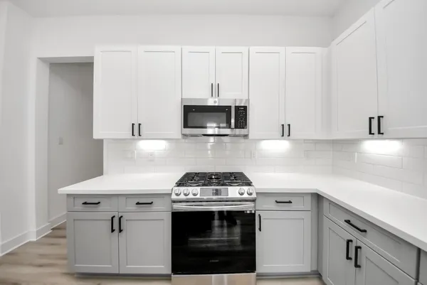 a kitchen with granite countertop a stove and a sink
