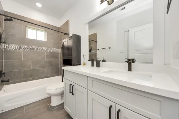 a bathroom with a sink a toilet and bathtub