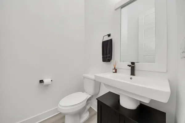 a bathroom with a sink toilet and mirror