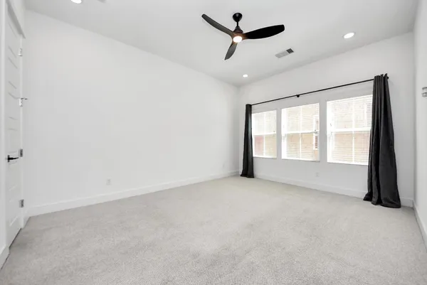 an empty room with a empty space and windows