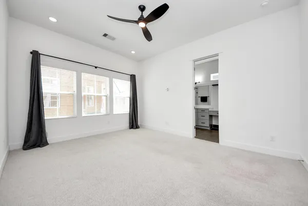 an empty room with windows and closet