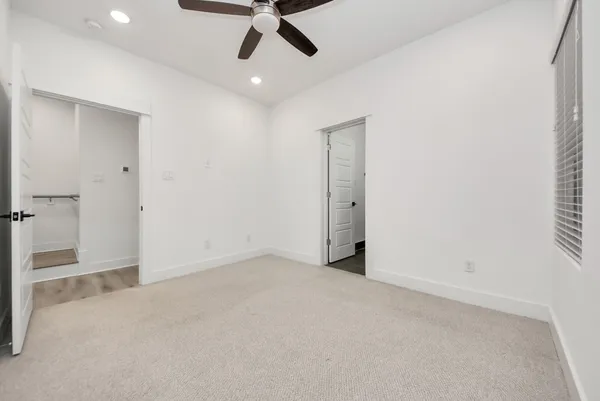 an empty room with a empty space and a ceiling fan