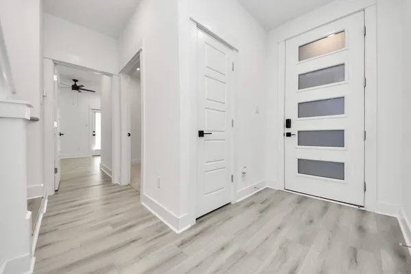 a view of an empty room with wooden floor