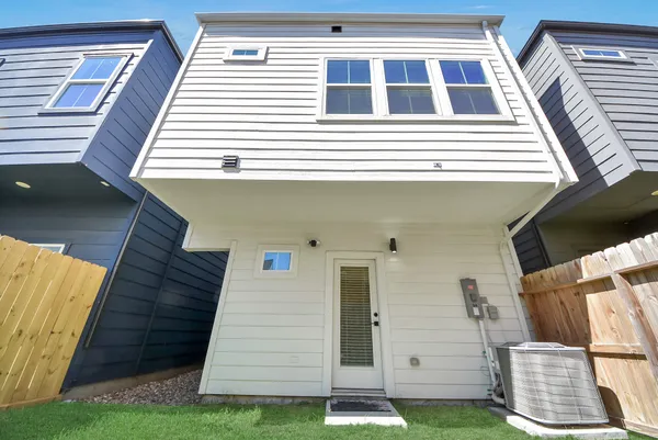 a view of a white house with many windows and a yard