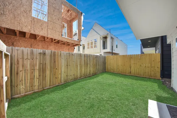 a view of a backyard with wooden fence