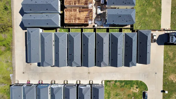 a view of building with wooden fence