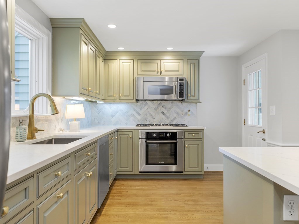 48 Fuller Brook Road Wellesley, MA 02482 - Photo 7 of 16 a kitchen with stainless steel appliances granite countertop a sink stove and cabinets