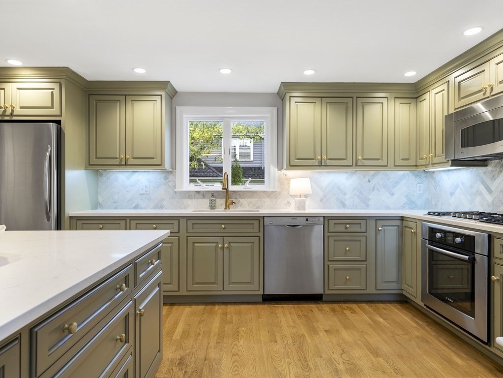 48 Fuller Brook Road Wellesley, MA 02482 - Photo 8 of 16 a kitchen with granite countertop a sink stainless steel appliances and cabinets